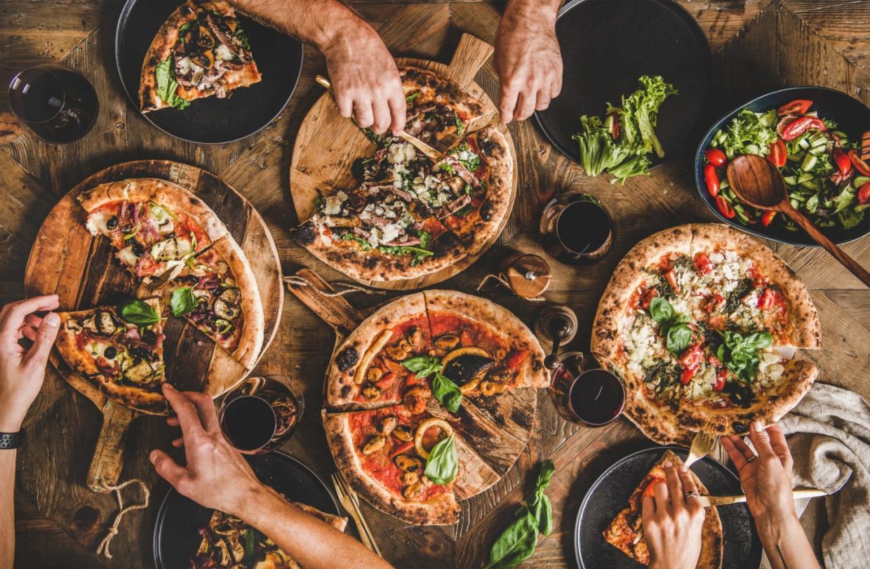 people-eating-various-kinds-of-pizza-and-drinking-wine-e1647246267630